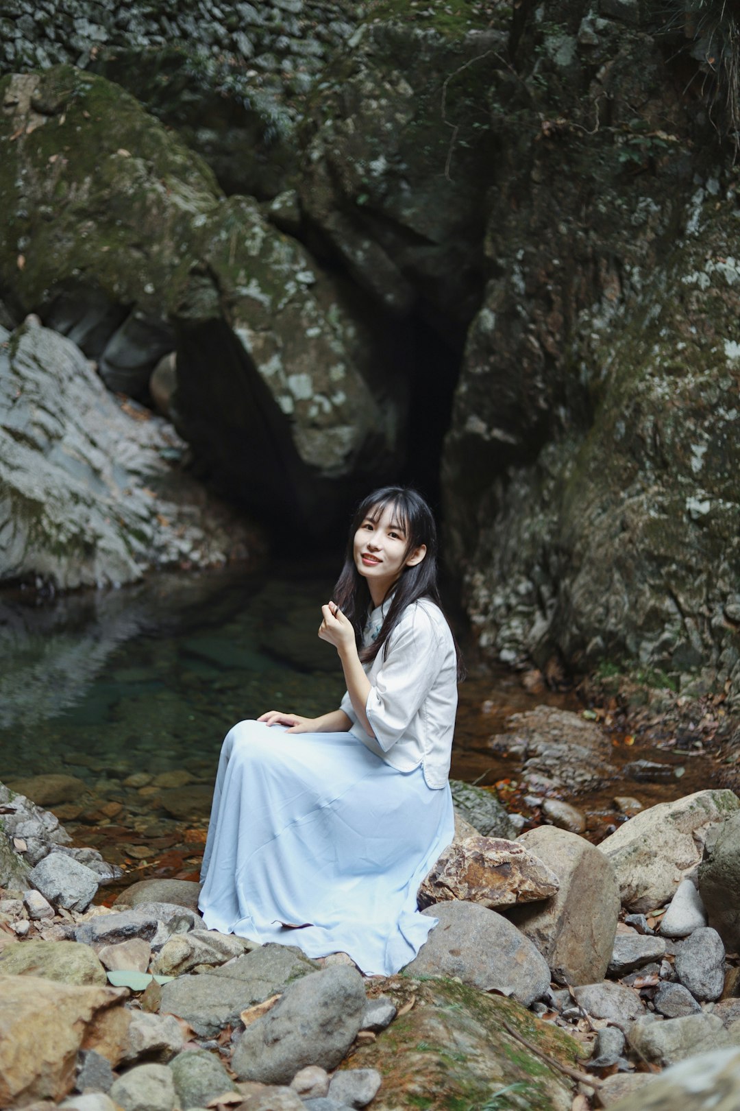 woman sitting on rock