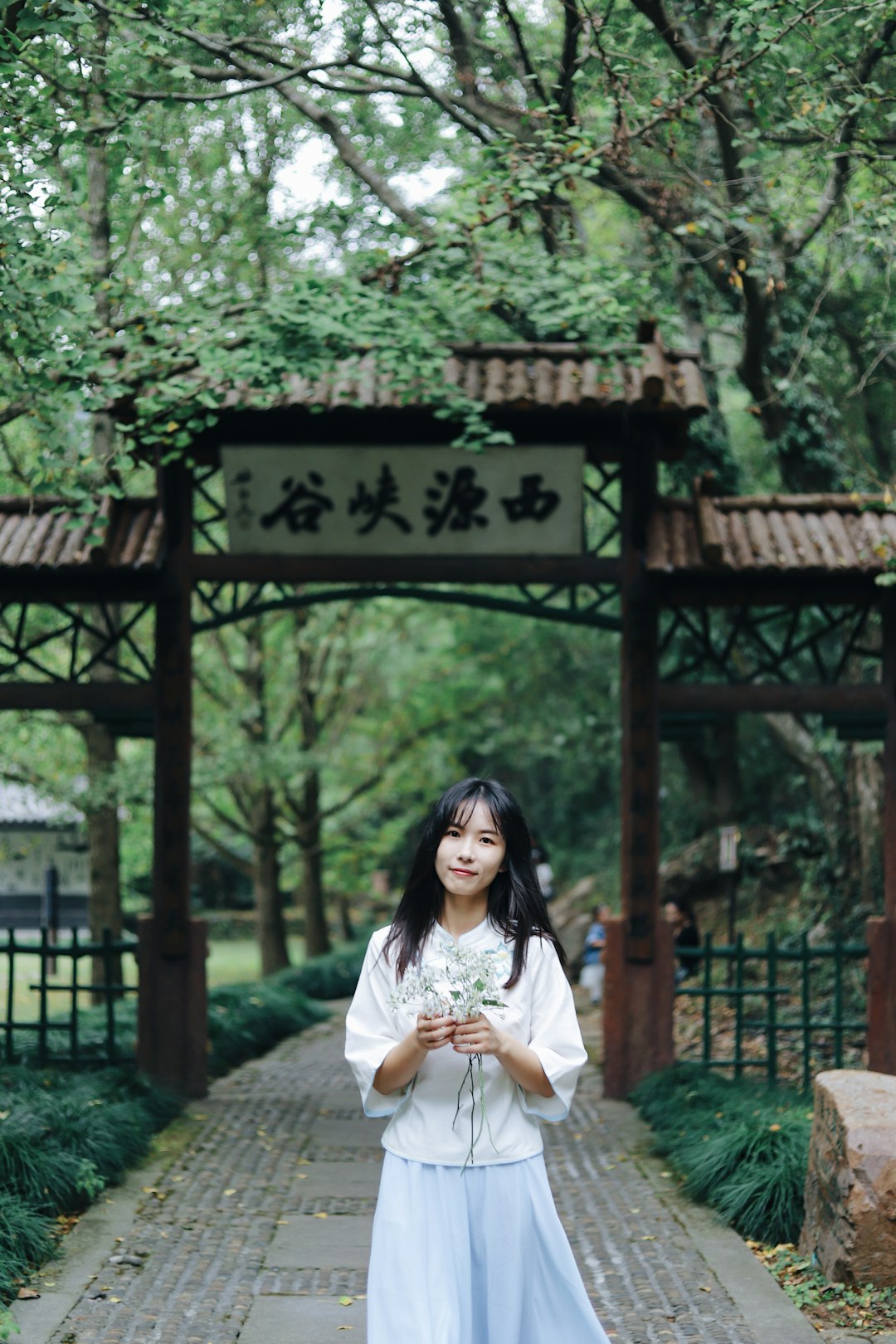 woman wearing white long-sleeved shirt and skirt during daytime