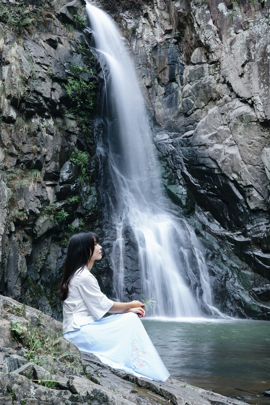 woman sitting near falls