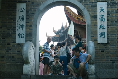 A group of diverse travelers enjoying a guided tour in front of a famous Chinese landmark.