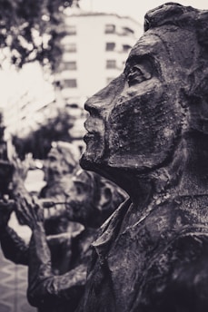 A detailed close-up of a textured bronze sculpture by Etienne Audfray.