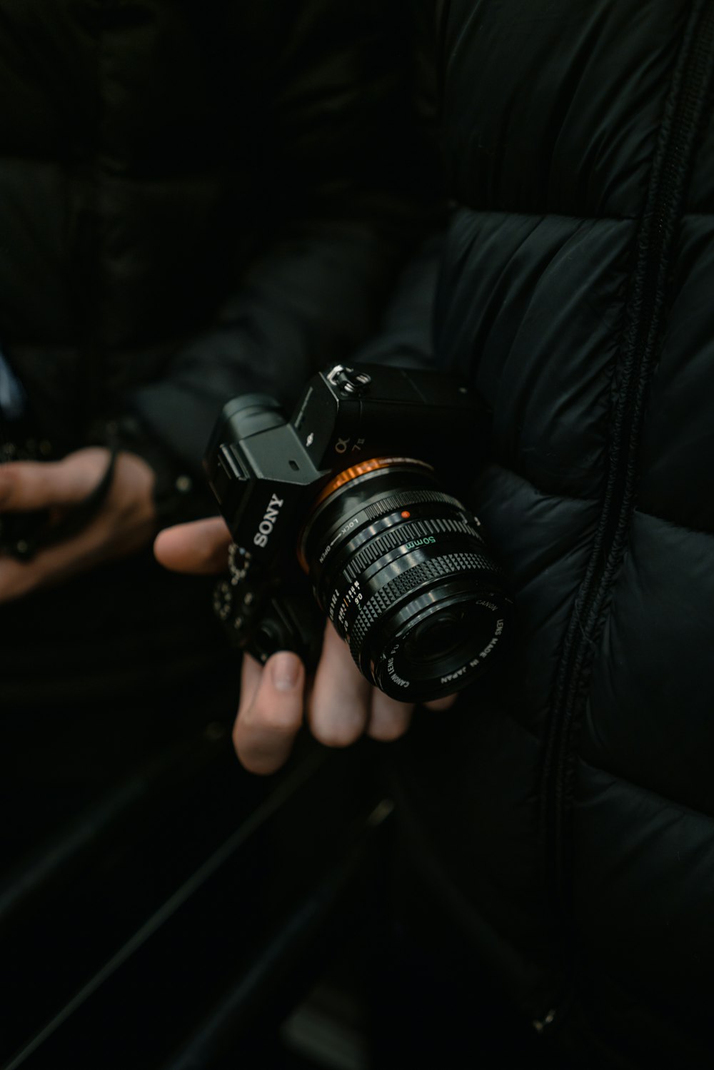 person holding black Sony DSLR camera