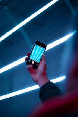 Futuristic dark-mode app interface with cyan accents on a smartphone screen