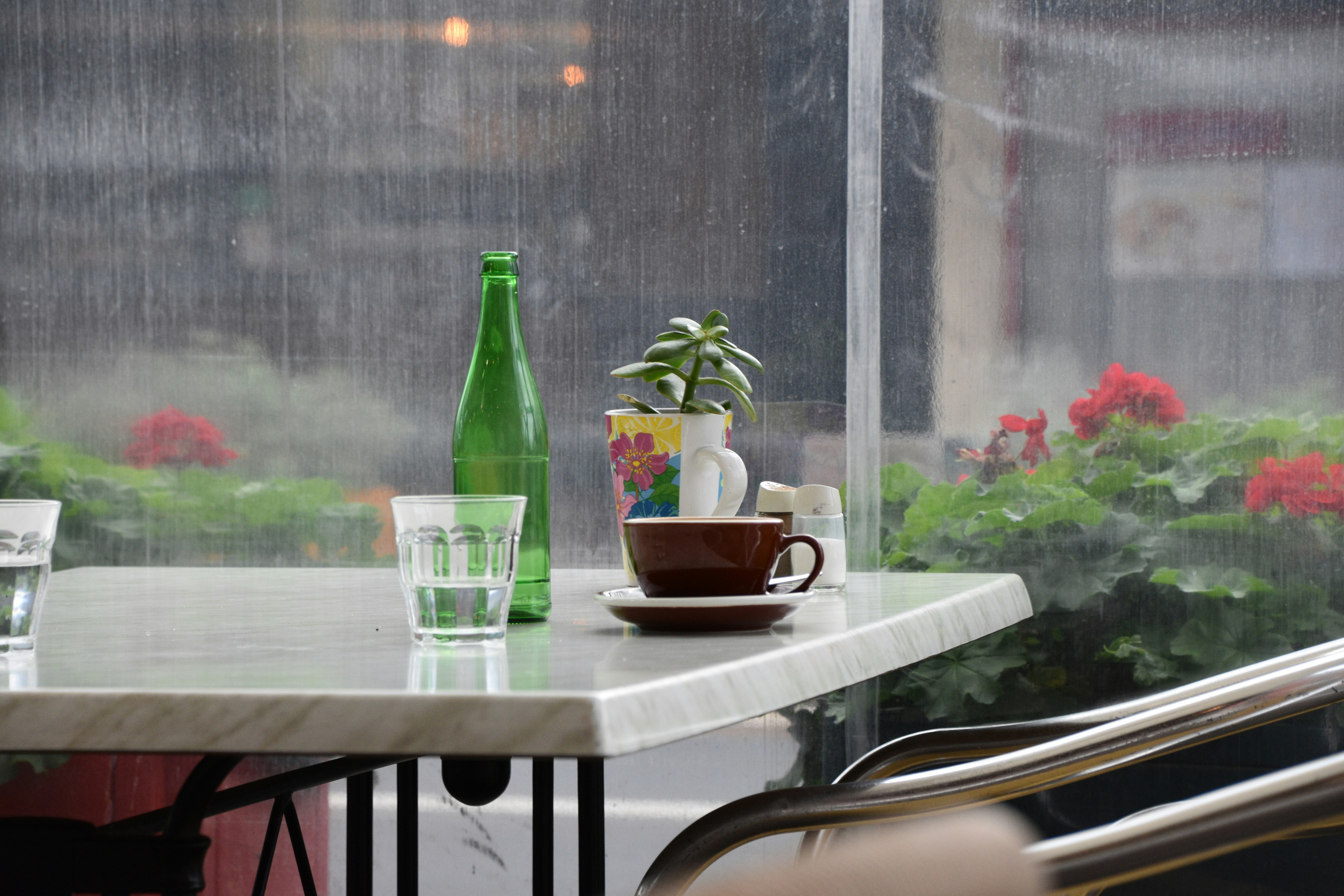a rainy window with a building in the background