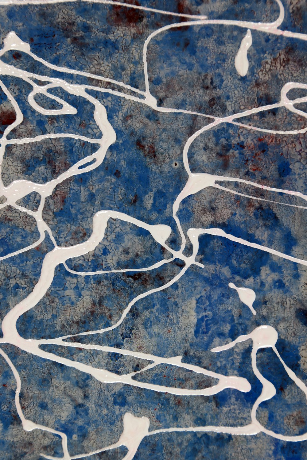 a close up of a blue and white abstract painting