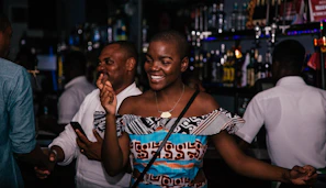 A group of people dancing and having fun during an evening event at the bar