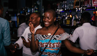 A group of people dancing and having fun during an evening event at the bar