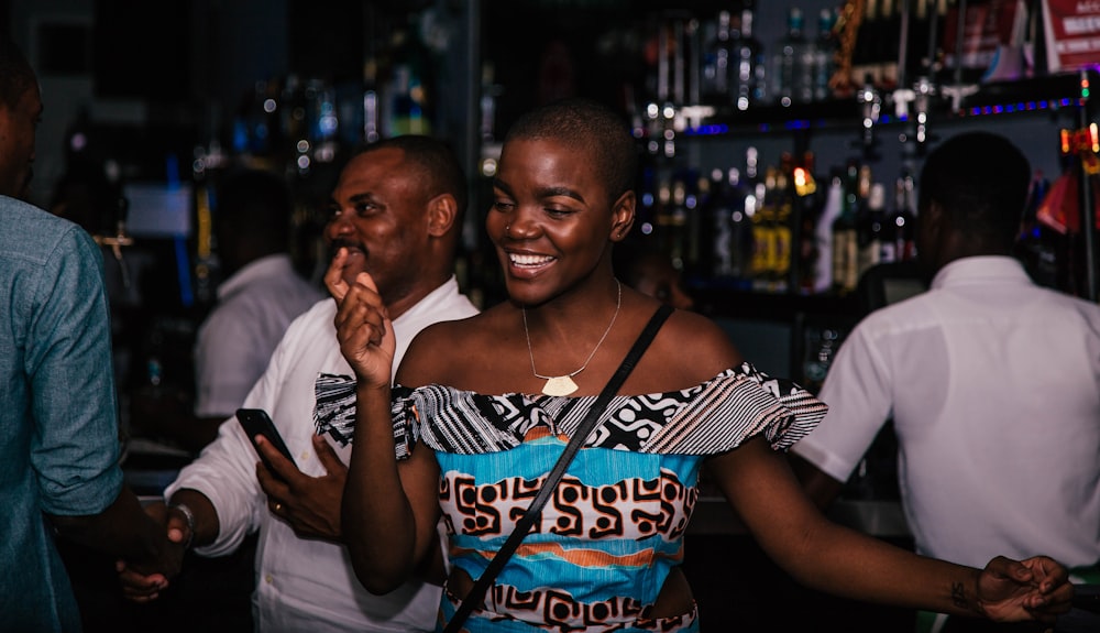 smiling woman wearing blue and grey top