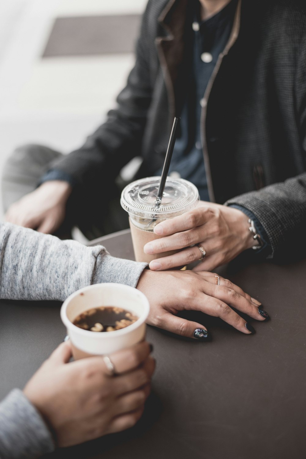 two persons holding drinks