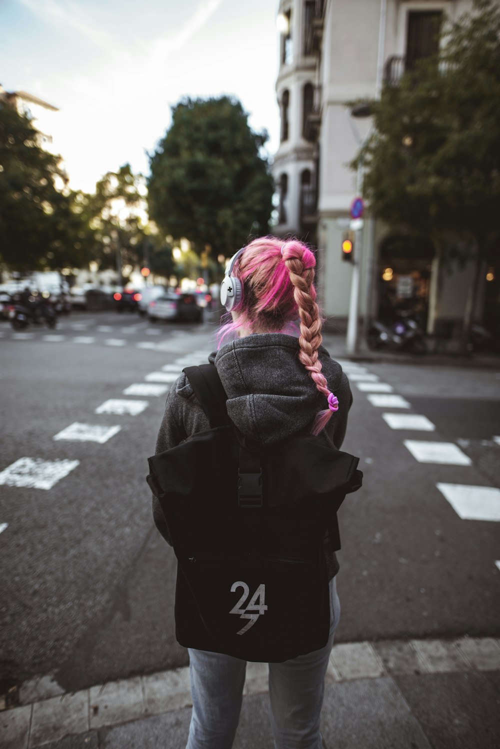 woman standing front of pedestrian lane at daytime