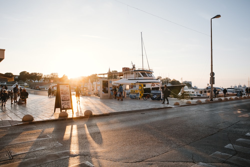 people standing beside boat at daytime