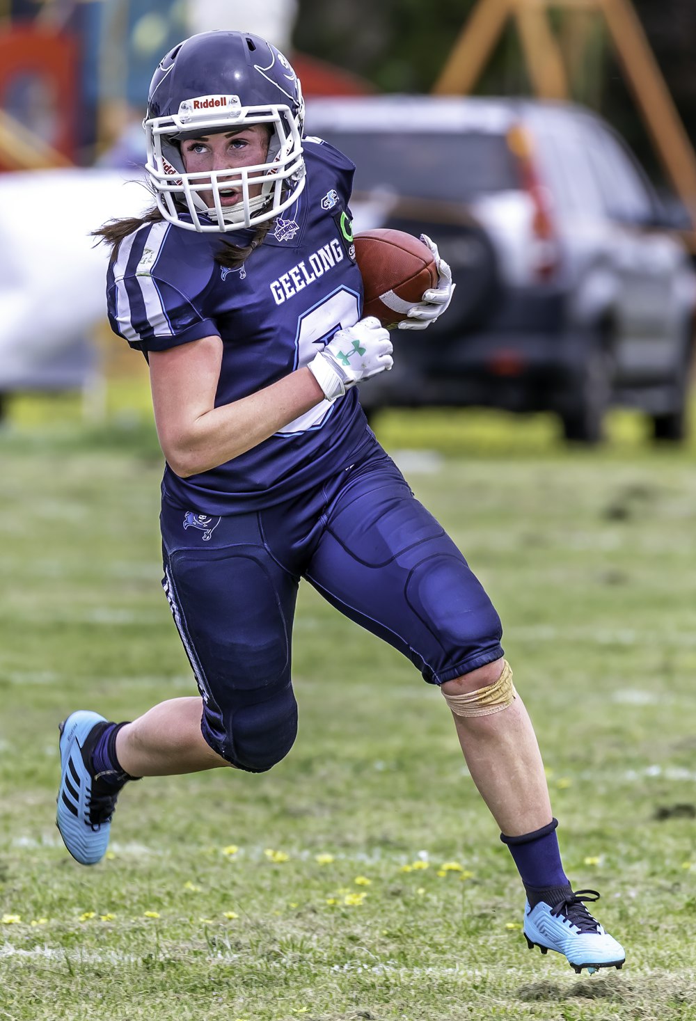 Woman In Blue Football Jersey Holding Football Photo Free