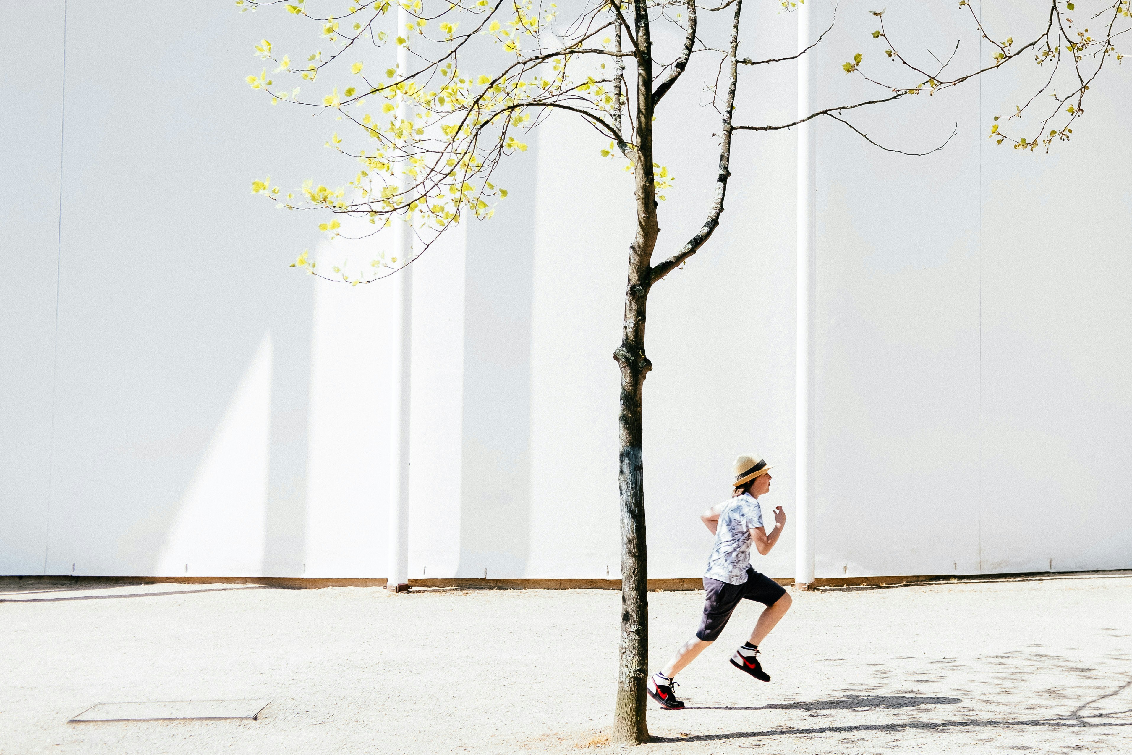 person in white T-shirt running
