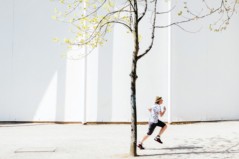 person in white T-shirt running