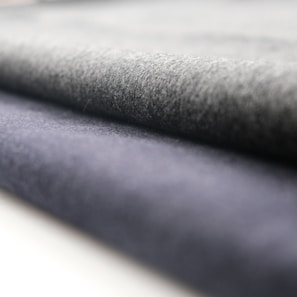 Close-up of smooth, high-quality fabric rolls in neutral tones