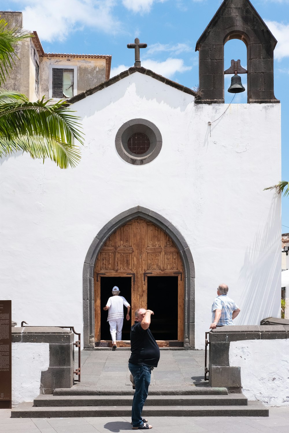 man standing front of church at daytime