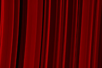 a red curtain with a black background