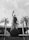 A prominent statue of a figure holding a trophy stands atop a large globe-like base inscribed with 'BRASIL 1958 1962'. The statue is surrounded by tall palm trees, and in the background, there's a large circular building with columns.