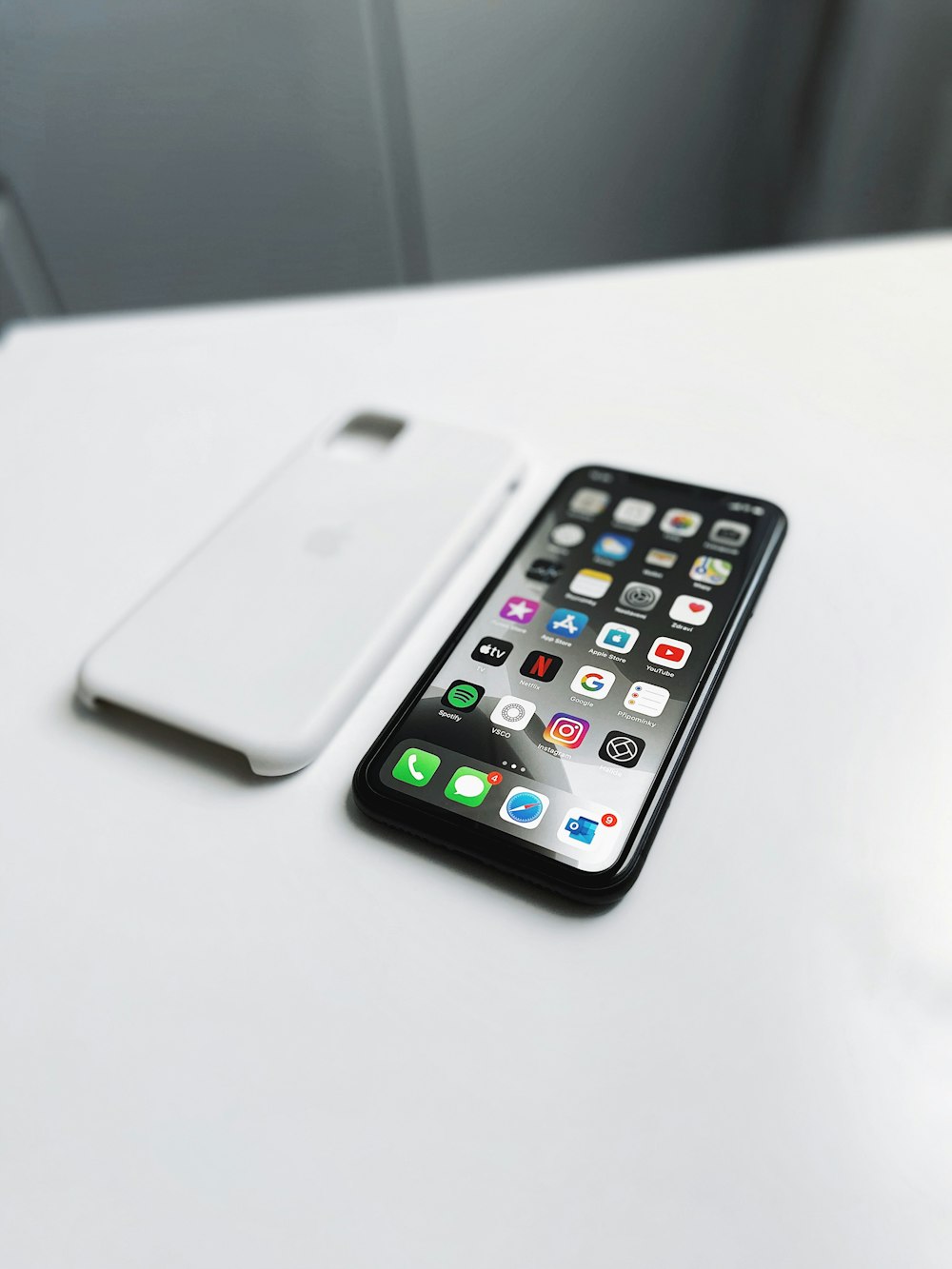 silver iPhone X near white case