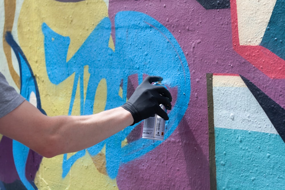 man painting on wall