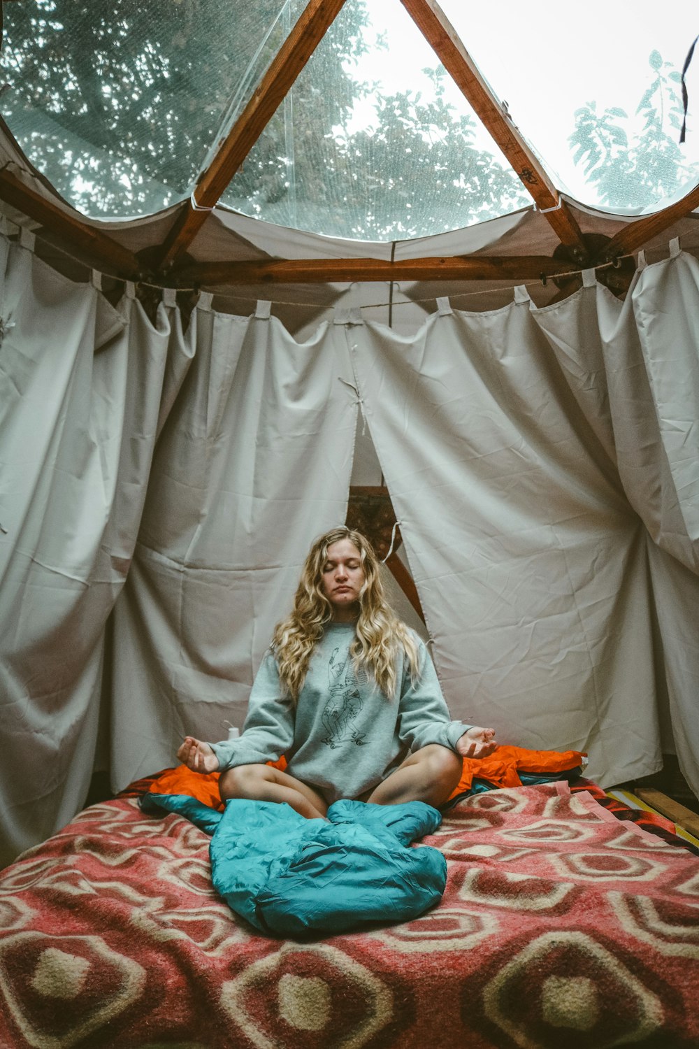 sitting woman on mattress inside room