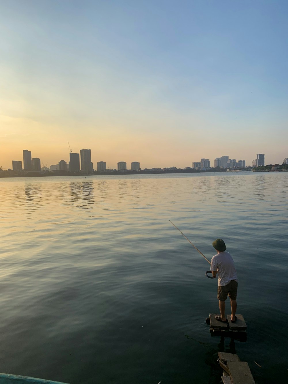 man fishing on body of water