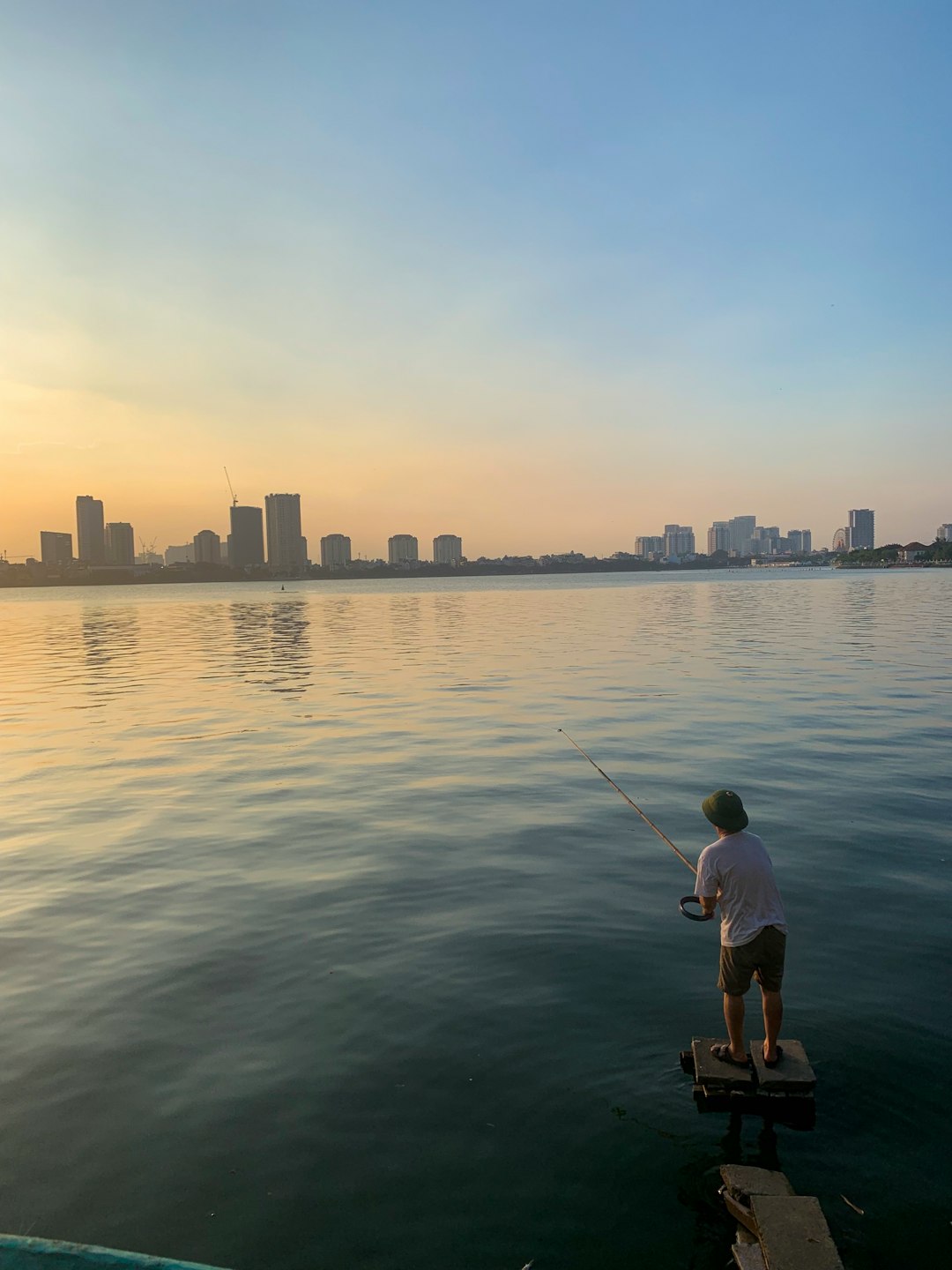 man fishing on body of water