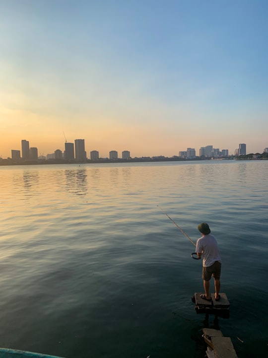 man fishing on body of water in West Lake Vietnam