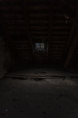 a dark room with a clock on the wall