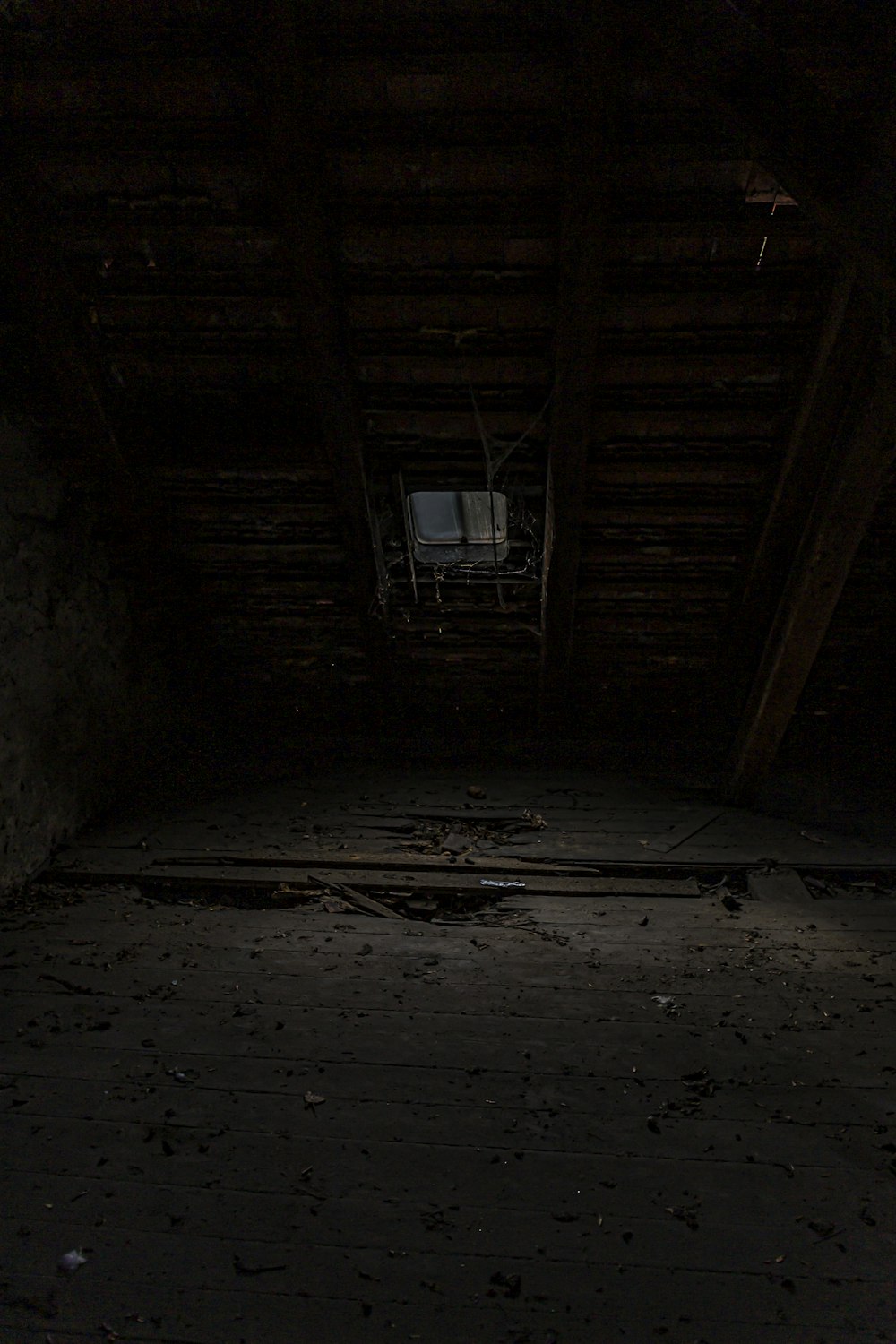 a dark room with a clock on the wall