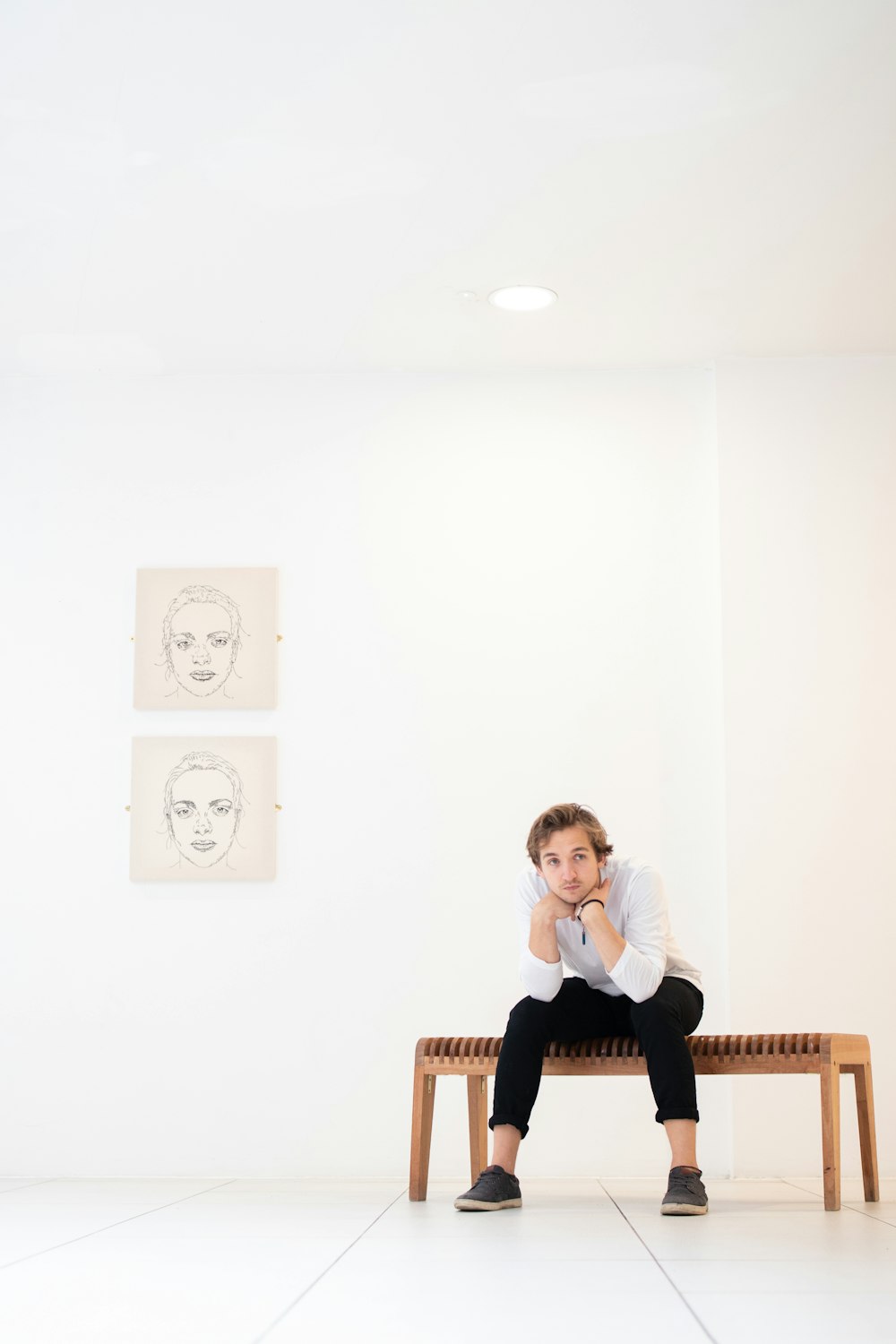 sitting man wearing white sweater