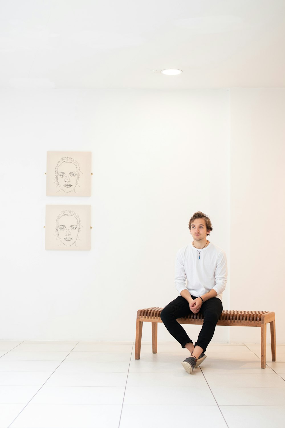 sitting man wearing white sweater