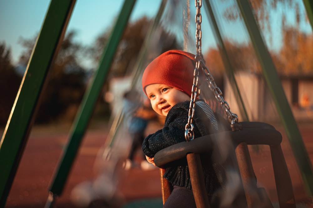 boy sitting on swing chair