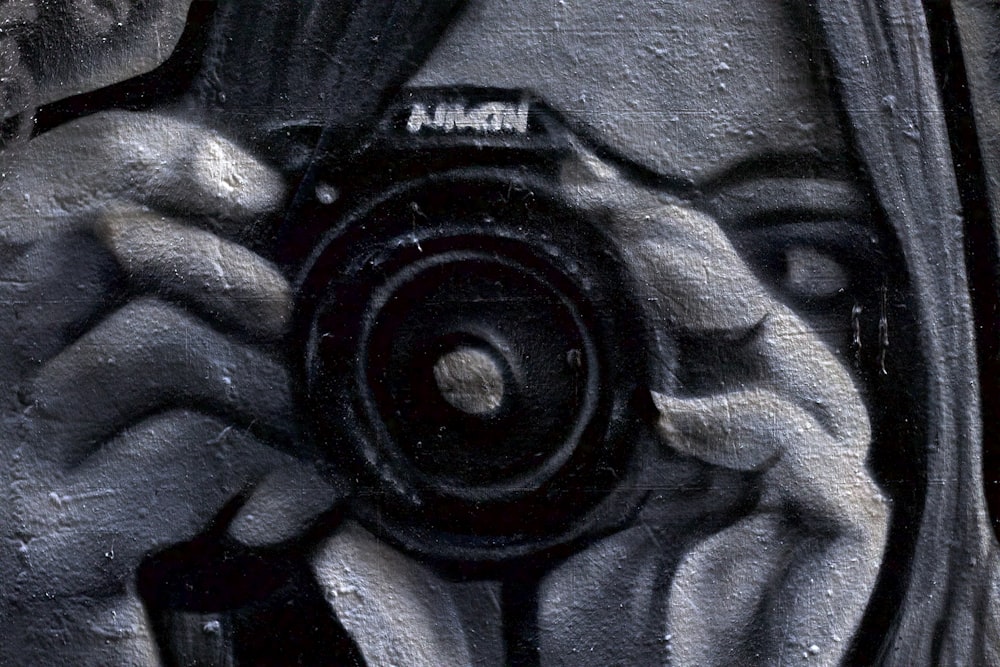 woman using black camera