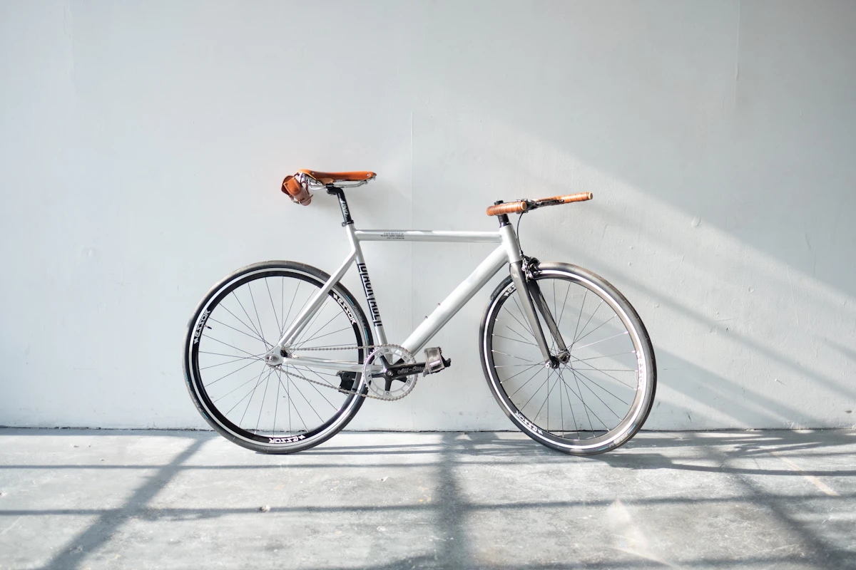 White road bike leaning against a white wall — minimalist and clean