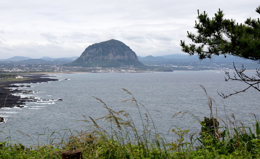 a body of water with a mountain in the background