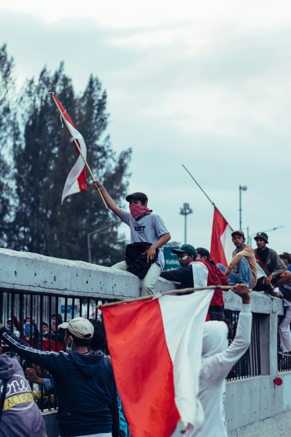 people holding white and red flag