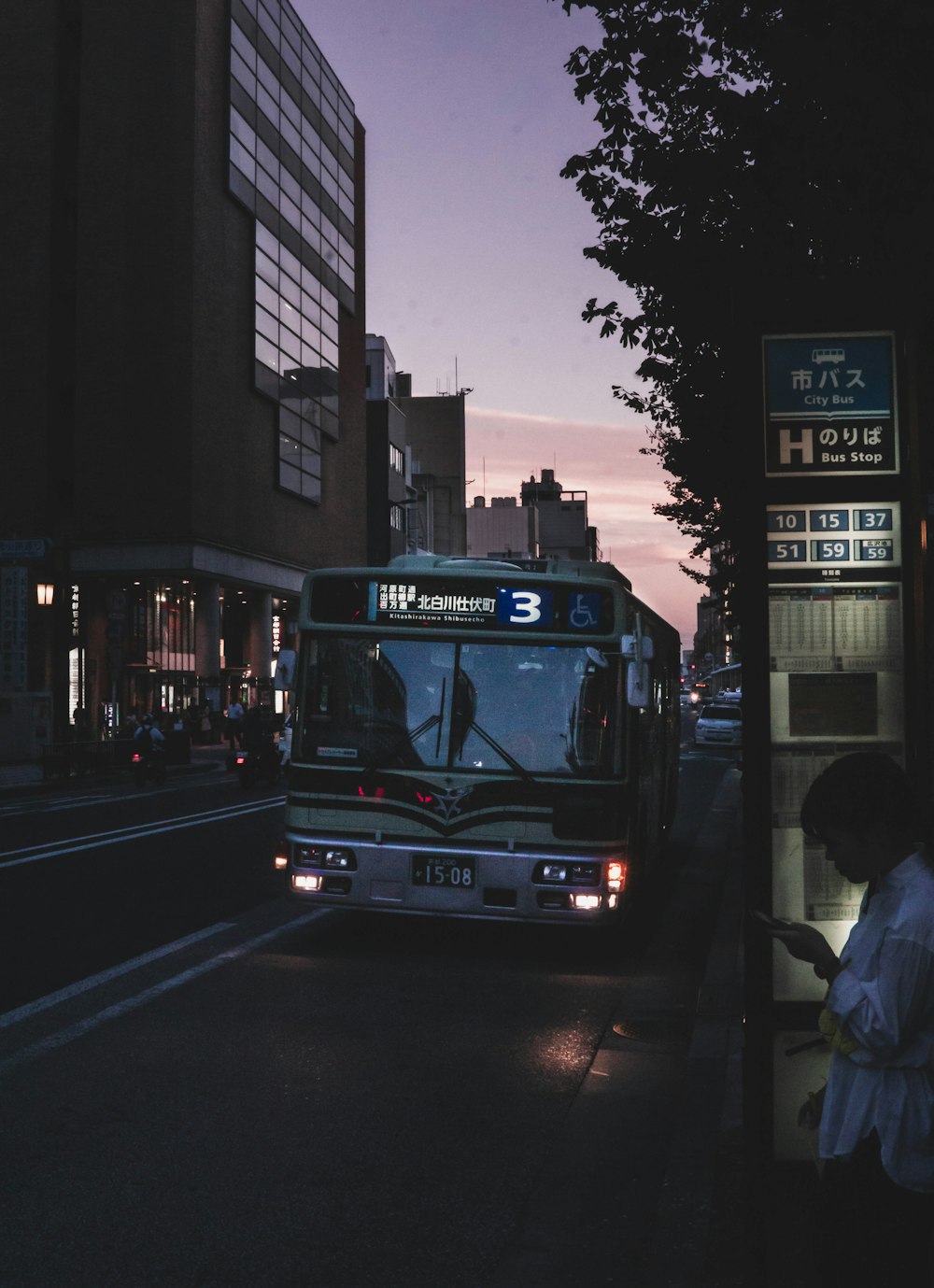 black bus on road at nighttime