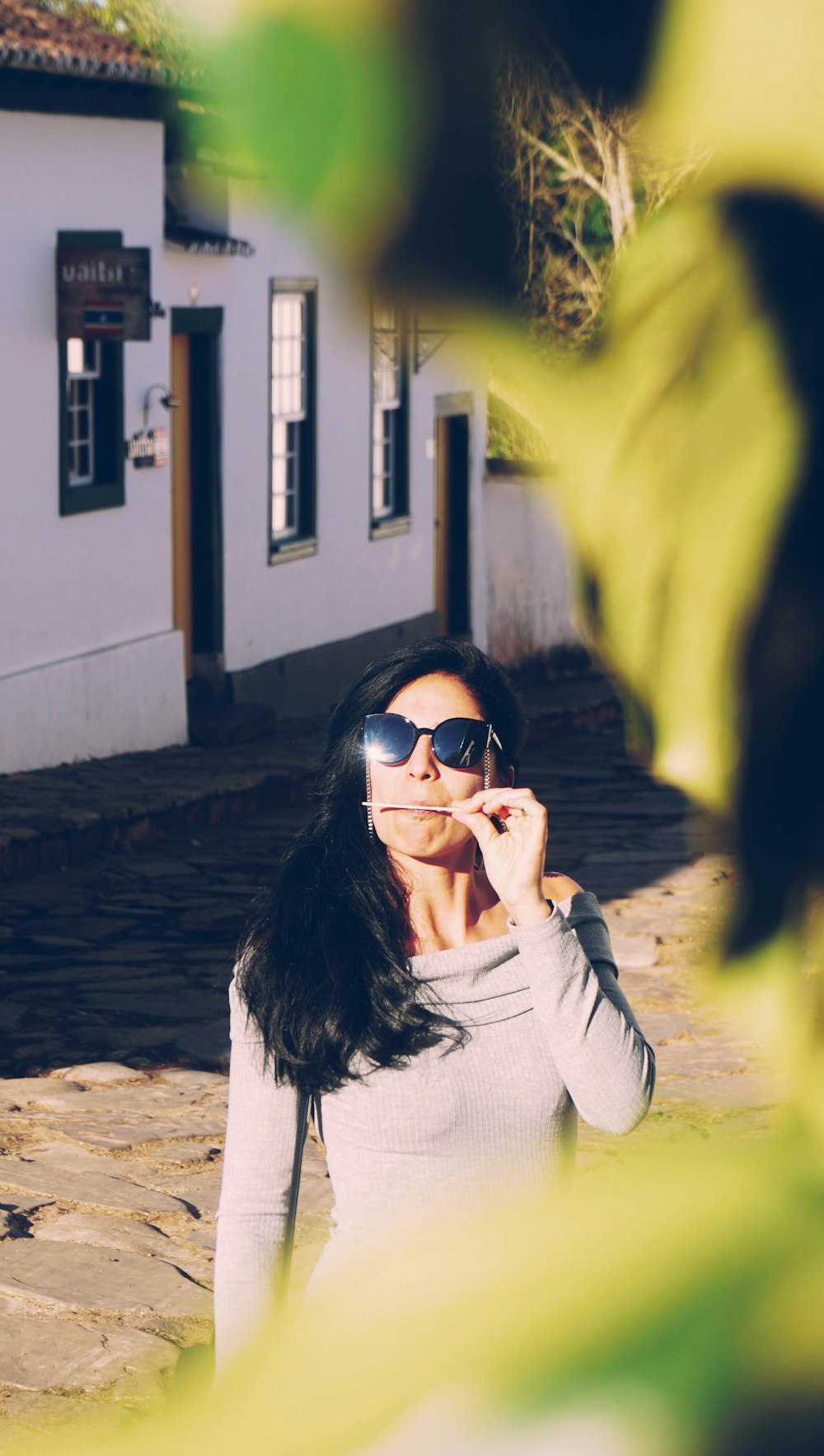 woman wearing black sunglasses and gray long-sleeved shirt