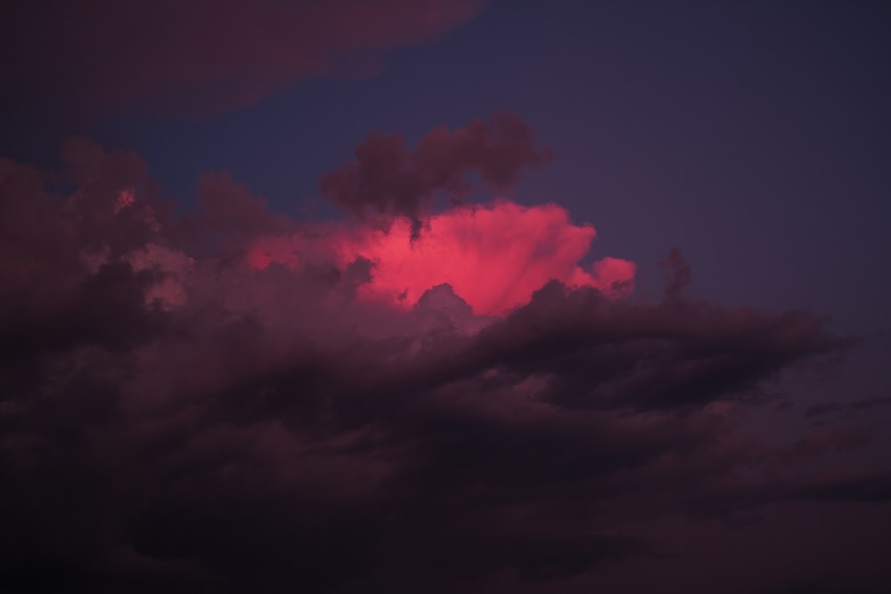 a pink cloud in the sky at night