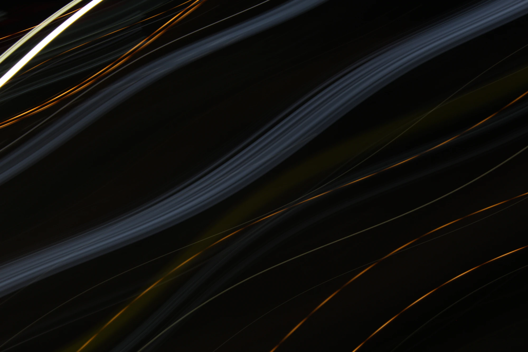 Blurred streaks of light in the dark, no clear line to read
