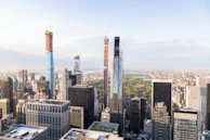 A panoramic view of Oslo’s eco-friendly cityscape with modern buildings and green rooftops under a clear sky.