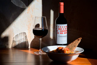 bowl of food beside wine glass