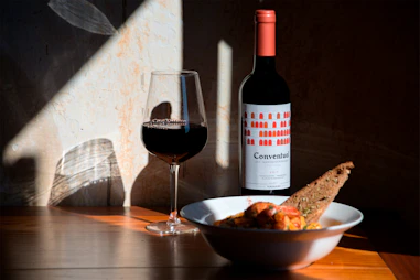 bowl of food beside wine glass