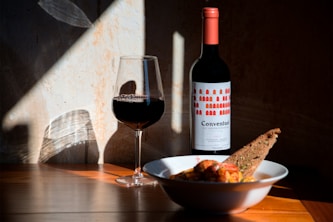 bowl of food beside wine glass