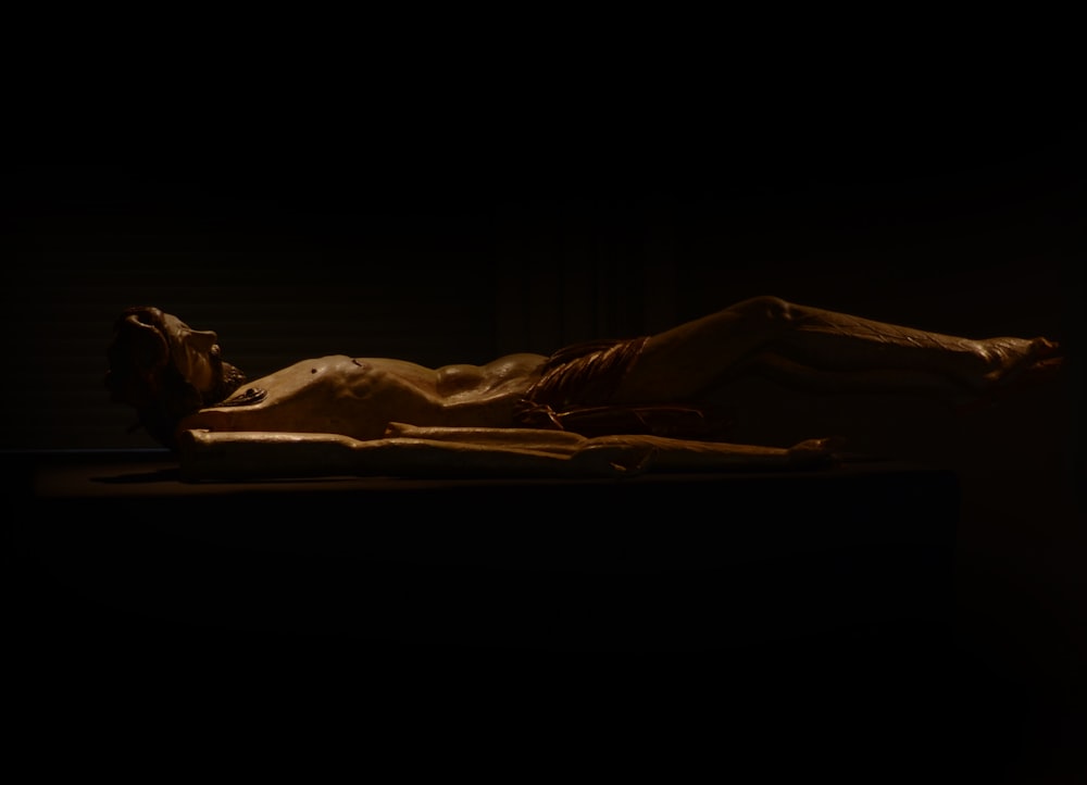 a person laying on a bed in the dark