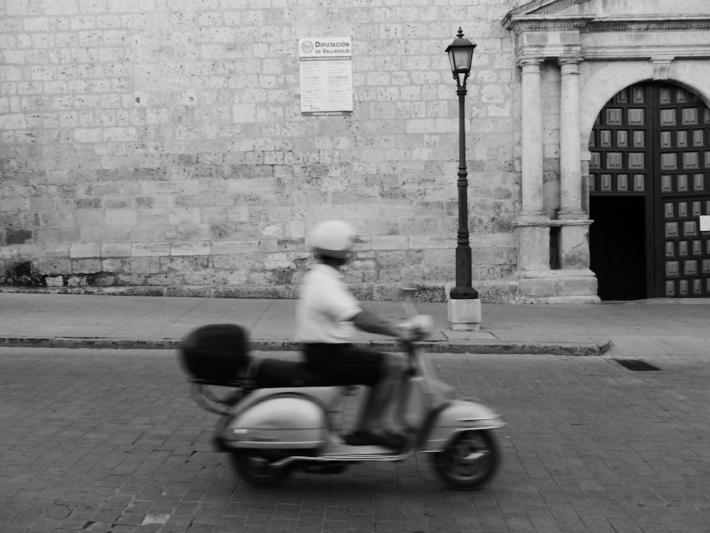 person riding motor scooter