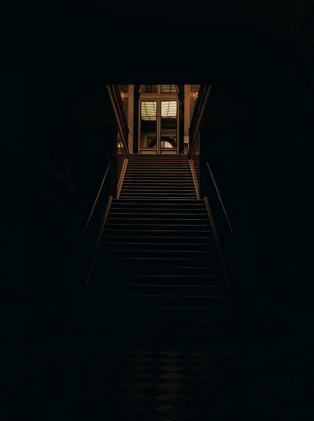 a staircase leading to a window in a dark room