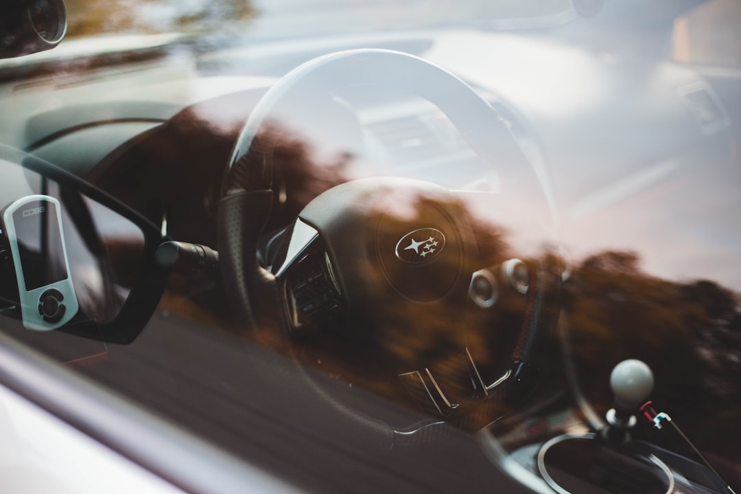 black Subaru vehicle steering wheel close-up photography