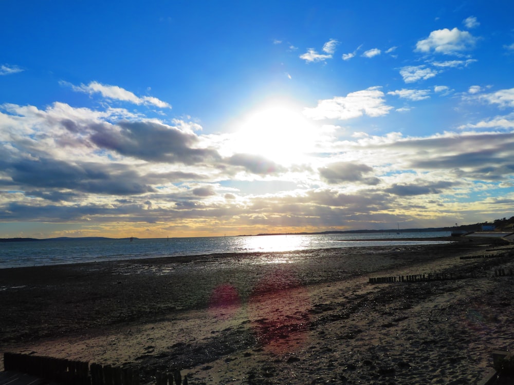 body of water under white and blue sky